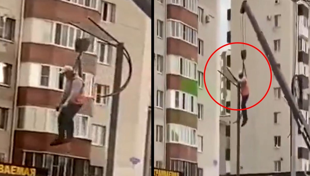 Vinçle sarkıtılan işçi sokak lambasını tamir etti