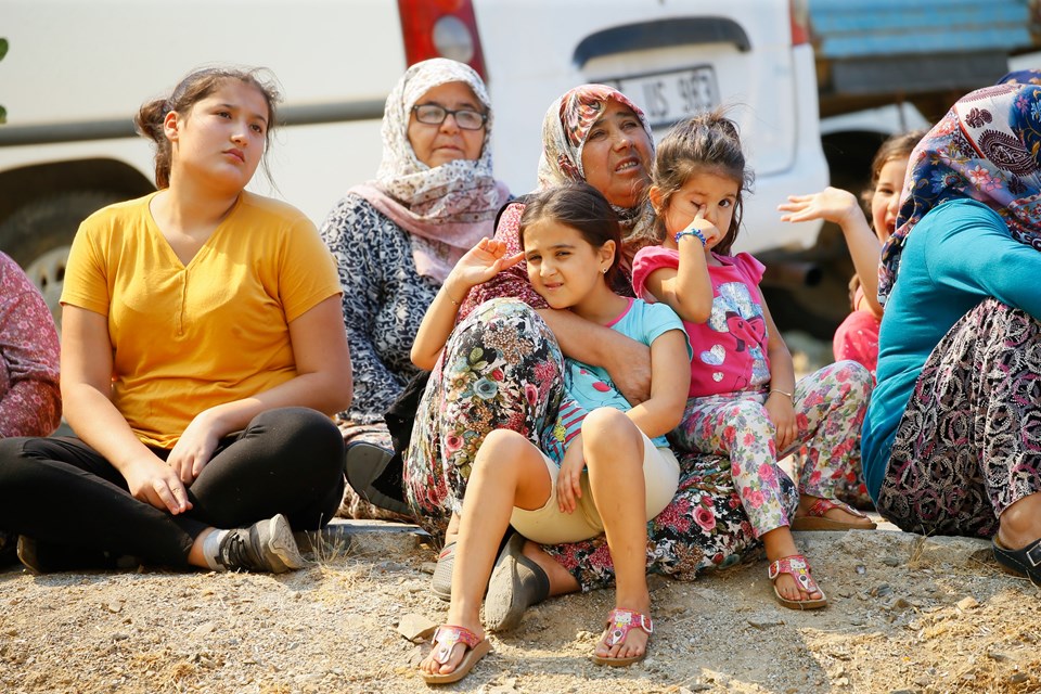 Mahalle sakinleri yangın söndürme çalışmalarını endişeyle izliyor.